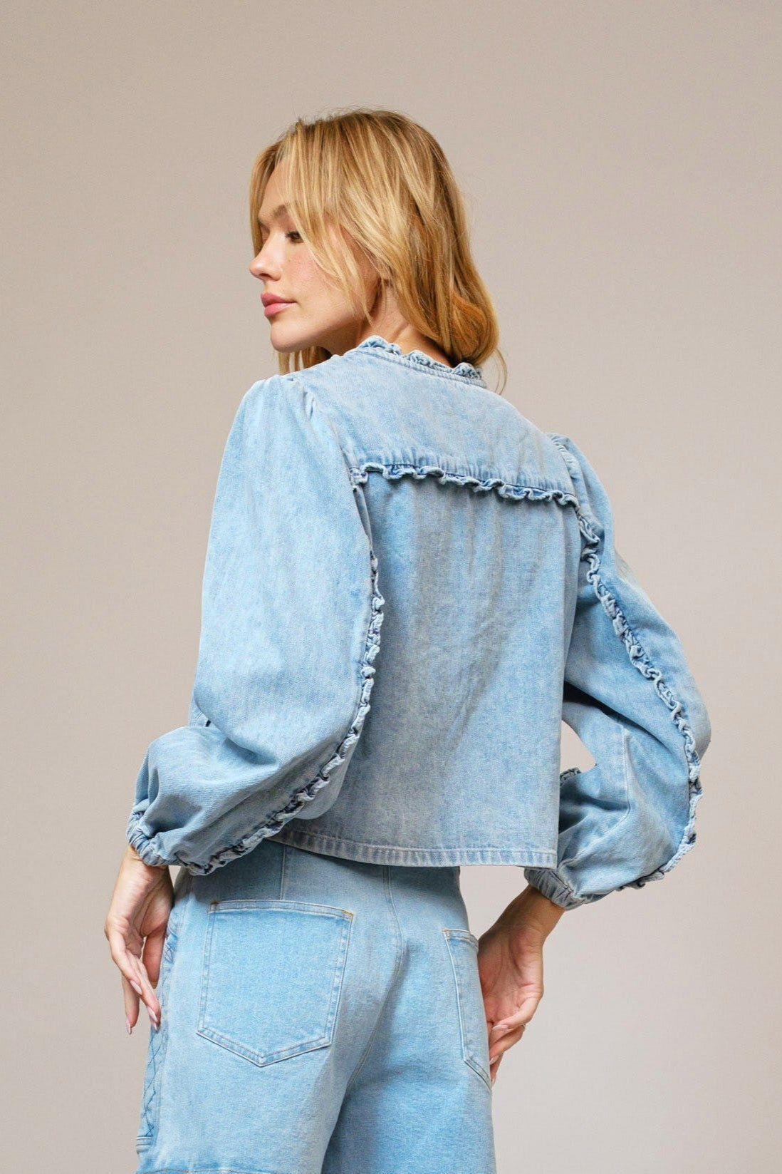 light denim jacket with ruffle detail on the back