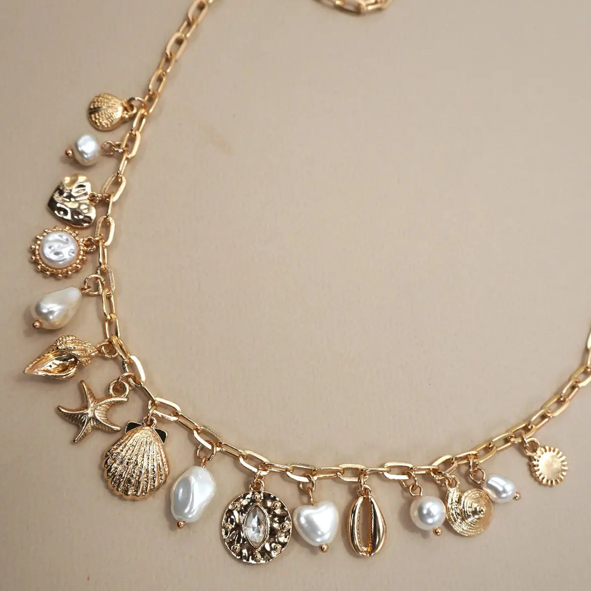 gold sea shell charm necklace with pearls