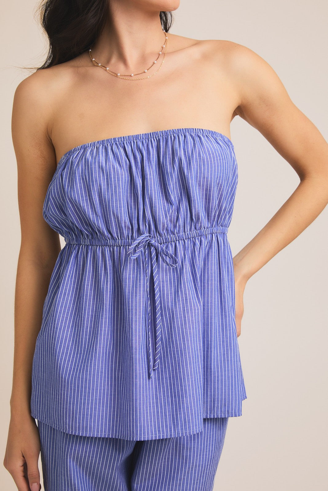 strapless white and blue peplum top with tie detail.