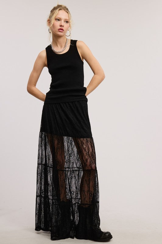 woman wearing a mesh lace black skirt with built in skirt underneath. 