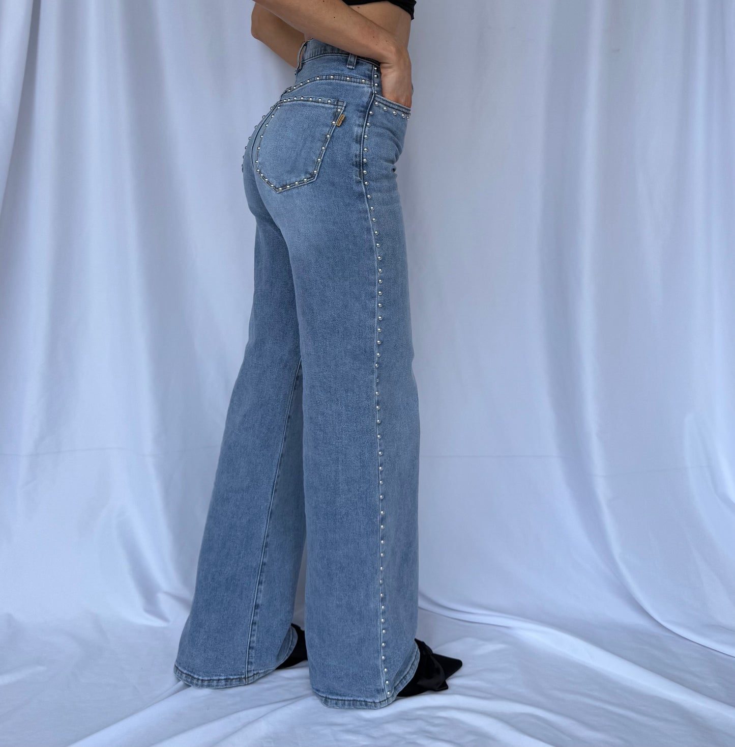 High waisted blue jeans with studded detail down the seams