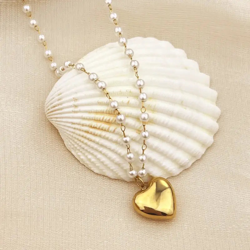 Gold pearl studded necklace with a heart pendant